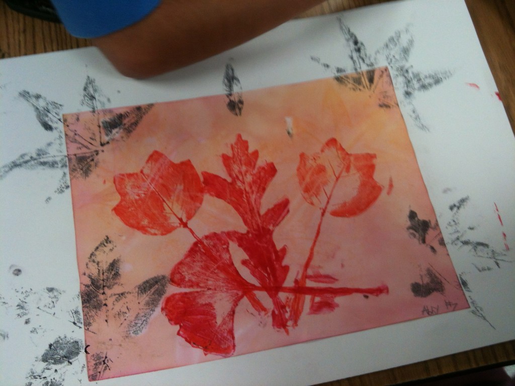 Red/orange leaf prints were made with rubber leaf stamps
