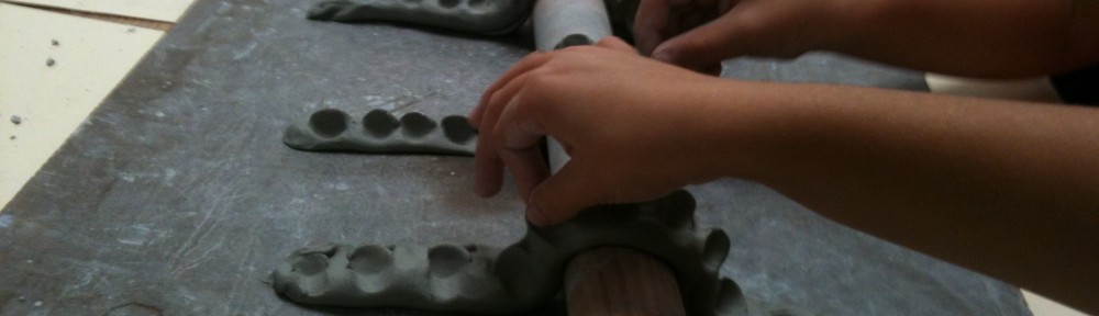Little hands make clay dragons. Remind students to keep dragons 'fat' - they will break if they get too thin.