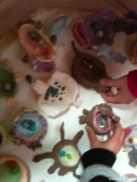 Second graders load their own pots into the kiln.