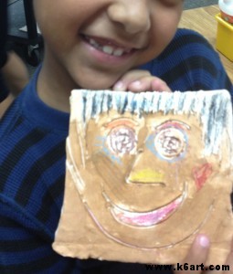 clay portrait tiles painted with tempera
