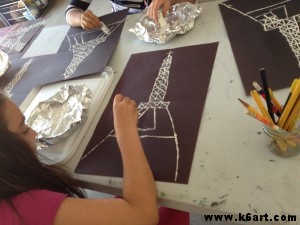 We used mat board scraps and white paint to print the Eiffel Tower.