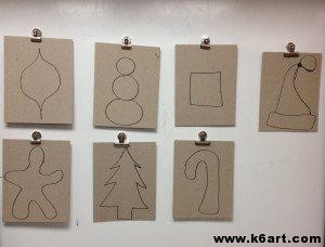 Students drew one holiday shape on cardboard, then cut it out.