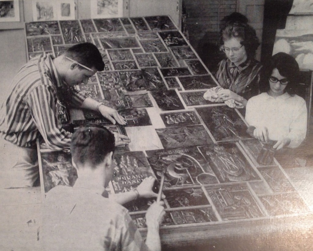 High school students create group art mural using individual copper repousse designs.