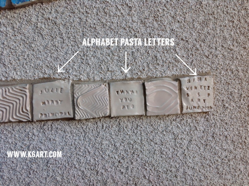 For the small text, we pressed alphabet pasta into the clay tiles.